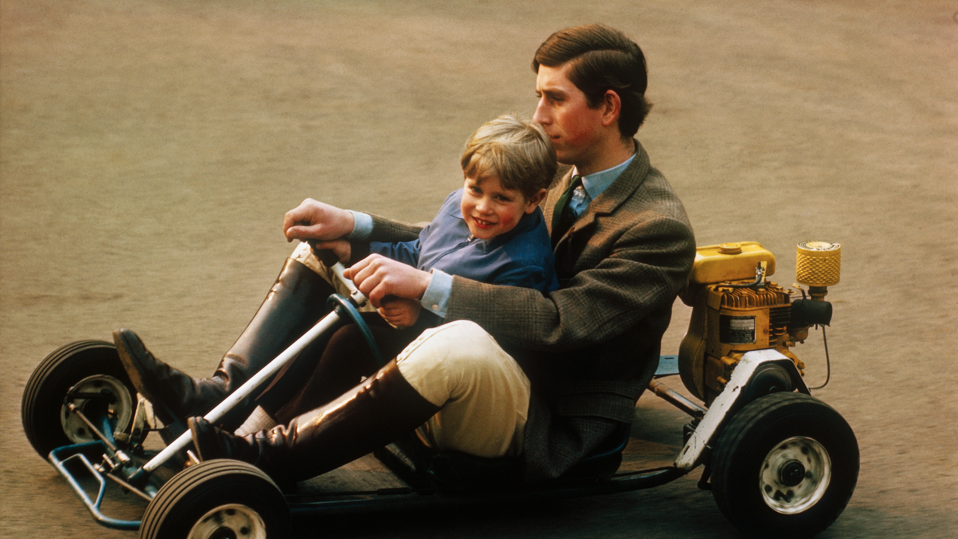 Go carting is a sport usually for one person at a time, but in the secluded grounds of the family home at Windsor, Prince Charles takes his younger brother Prince Edward for a spin in this photograph in 1969