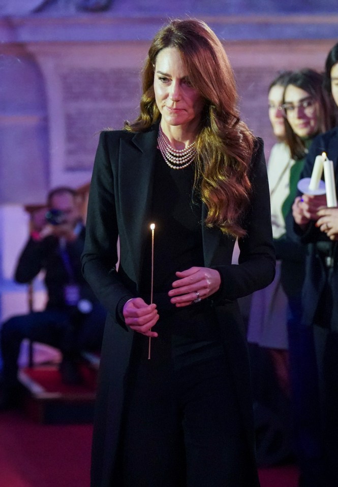 Princess Catherine holding a lit candle at a Holocaust Memorial Day ceremony.