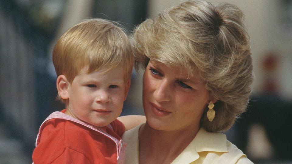 Princess Diana wears yellow blouse while holding Prince Harry as a toddler
