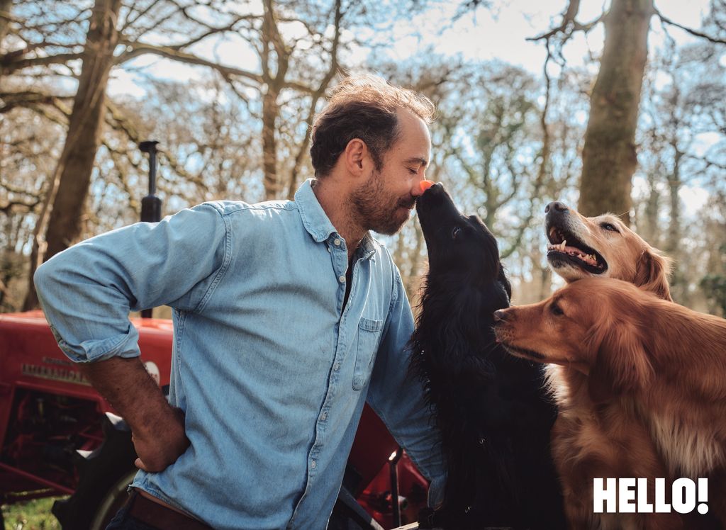 A black cocker spaniel licking his owner on the face
