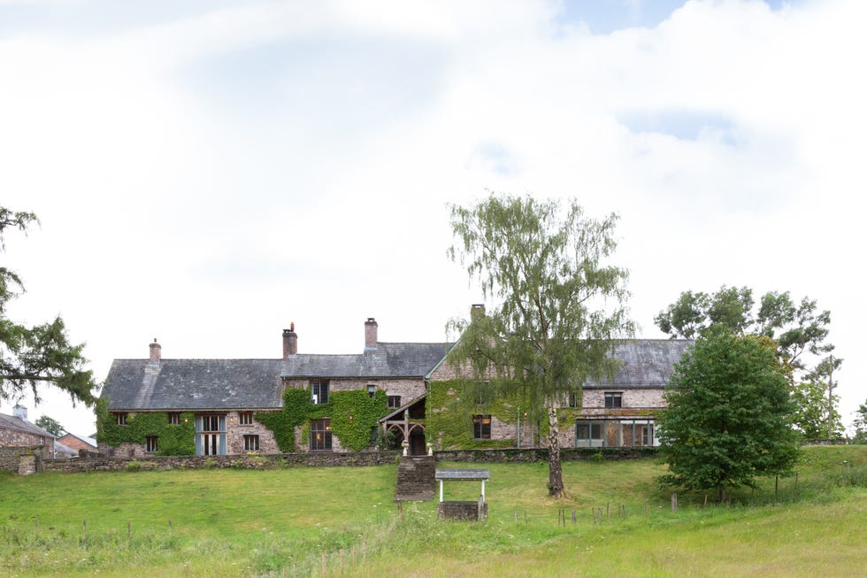 a large house with a stone wall