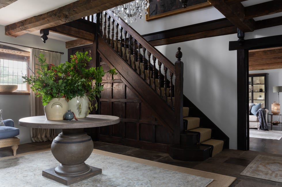 a staircase with a table and potted plants on it