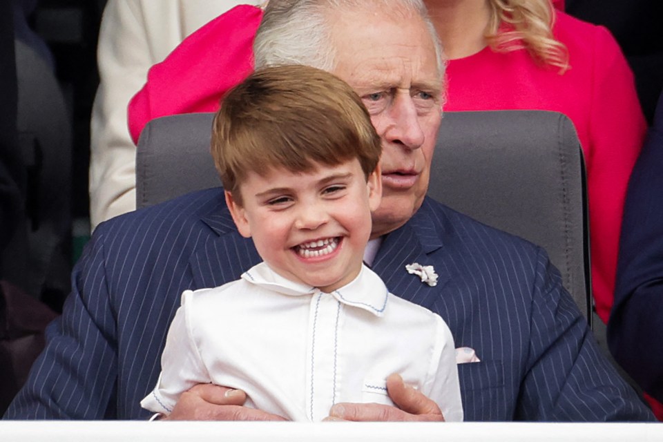 Prince Louis of Cambridge sitting on Prince Charles' lap at the Platinum Jubilee Pageant.