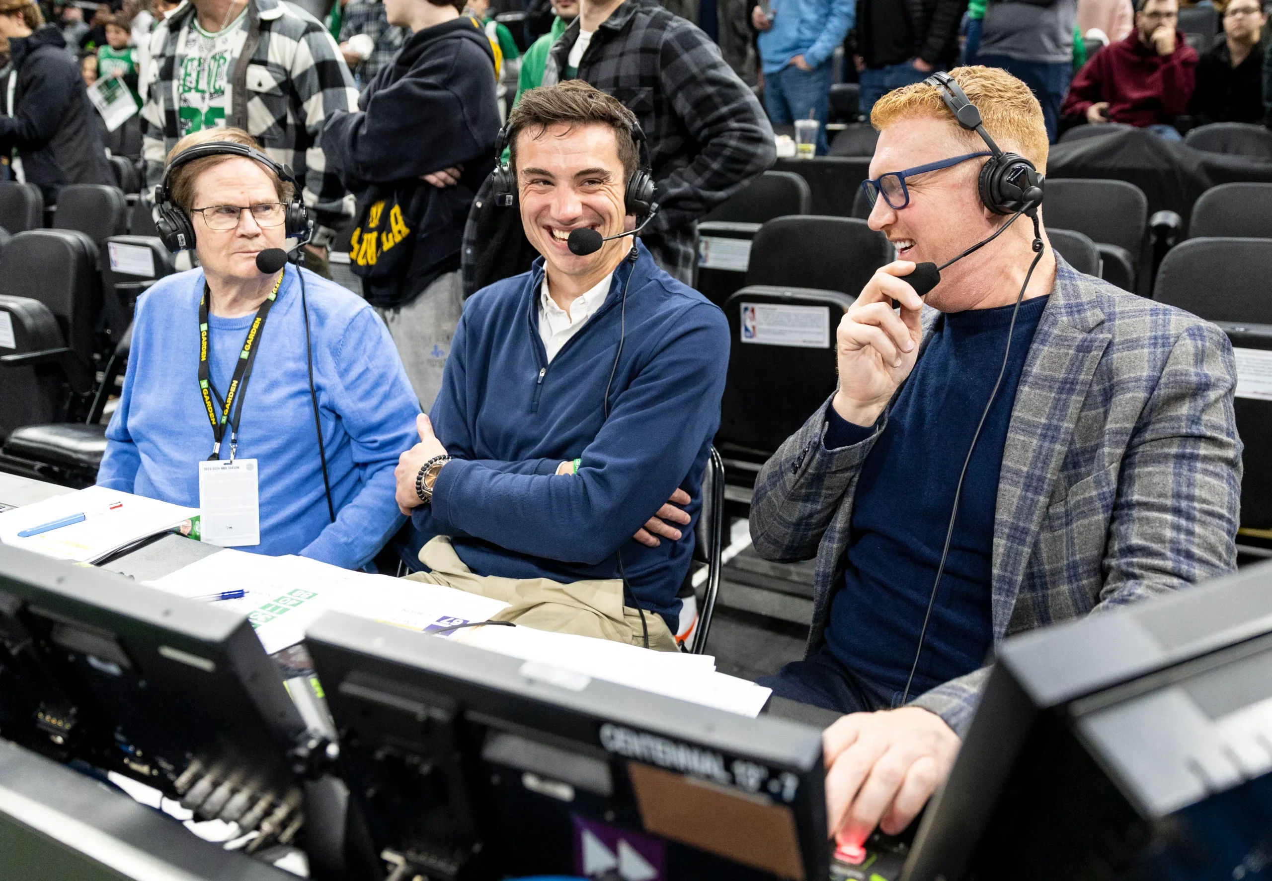Celtics play-by-play voice Drew Carter, center, and analyst Brian Scalabrine, right, talk after a game at TD Garden.