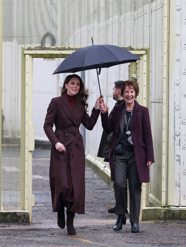 Catherine, Princess of Wales visits HMP Styal on Feb. 11 in Cheshire, England, tartan coat, Blaze Milano, burgundy