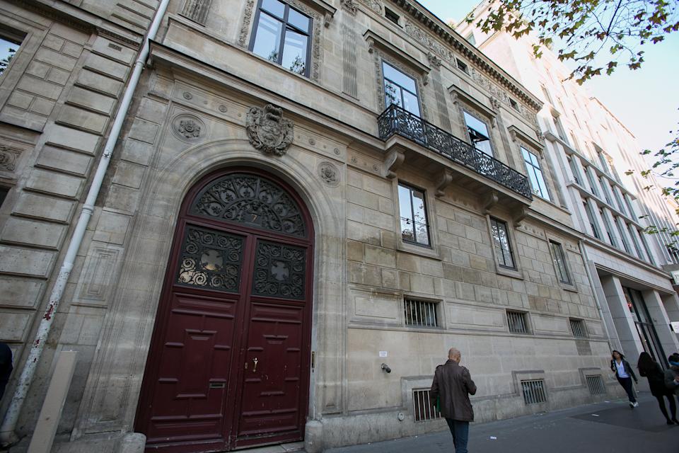 Street view of building with ornate door.