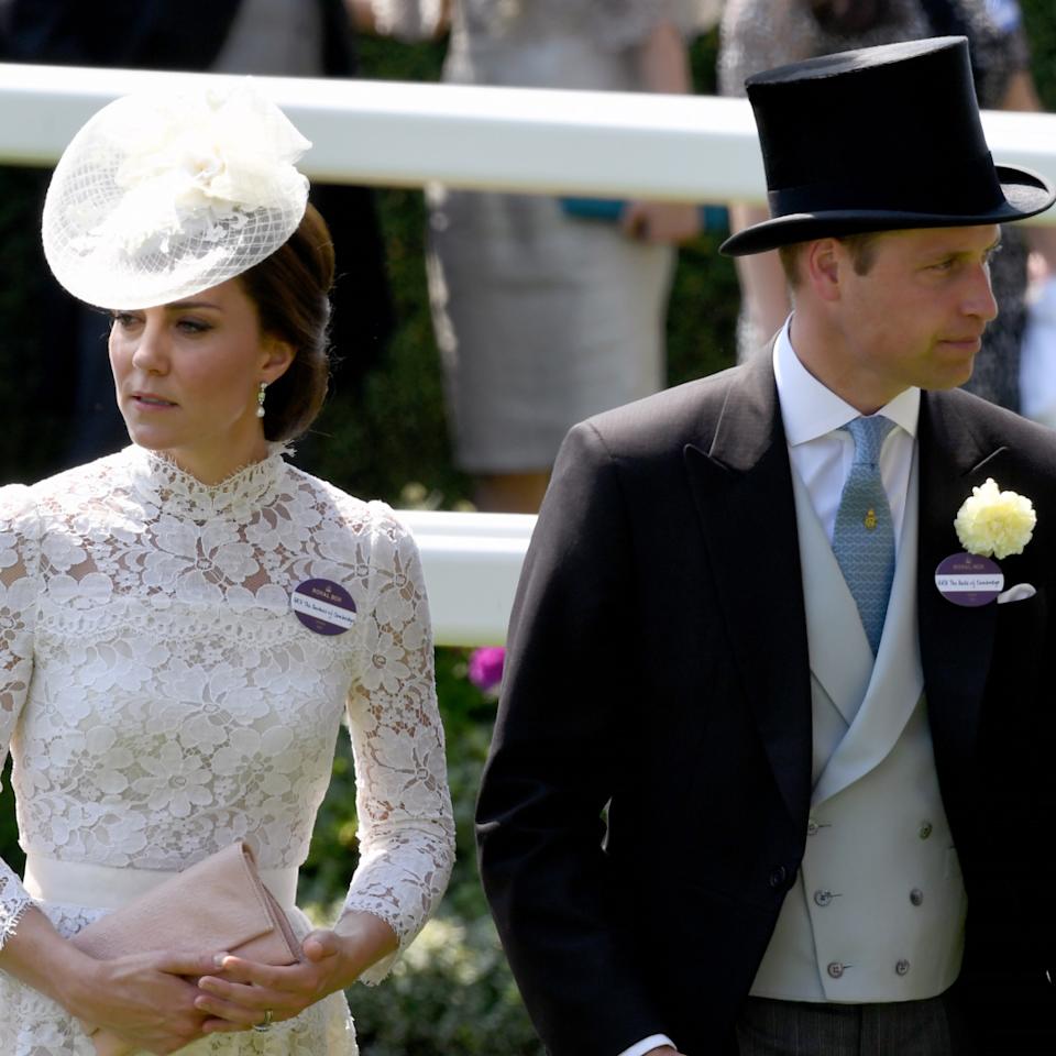 Kate Middleton wears a white lace dress and matching hat and Prince William wears a top hat and tails at Ascot.