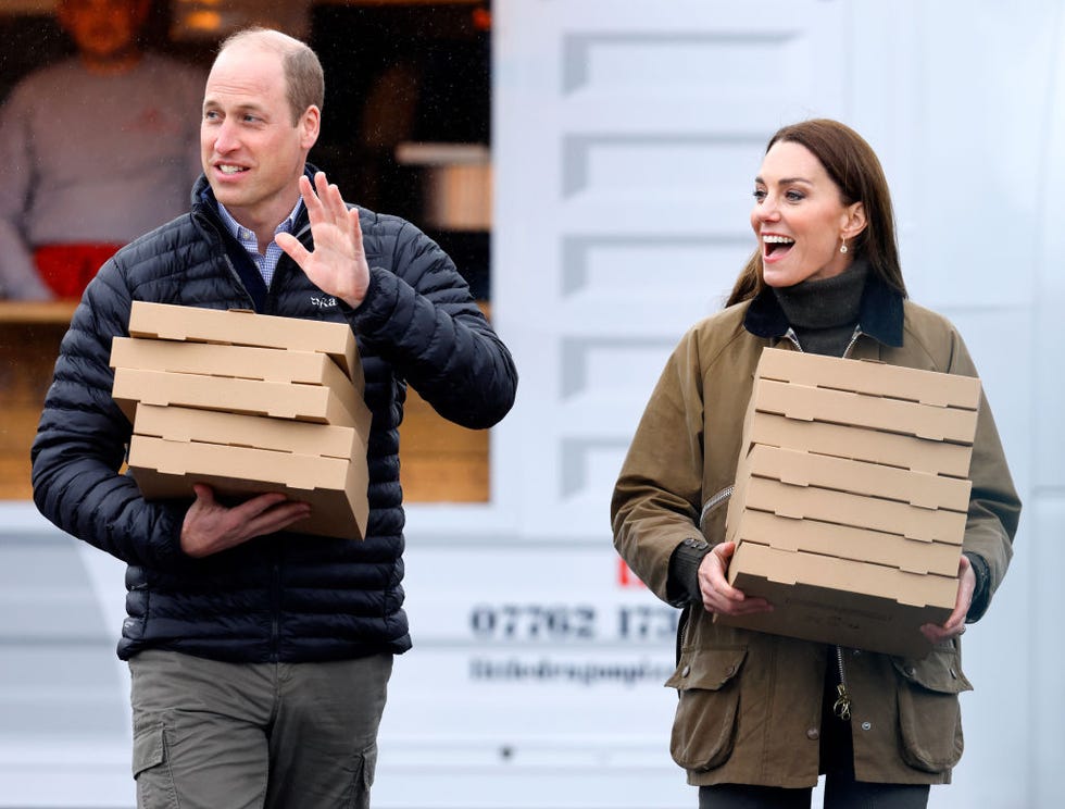 The Prince And Princess Of Wales Visit Wales - Day One merthyr tydfil, united kingdom april 27: (embargoed for publication in uk newspapers until 24 hours after create date and time) prince william, prince of wales and catherine, princes of wales carry takeaway pizza boxes, collected from a pizza van, as they visit dowlais rugby club on april 27, 2023 in merthyr tydfil, wales. the prince and princes of wales are visiting the country to celebrate the 60th anniversary of central beacons mountain rescue and to meet members of local communities. (photo by max mumby/indigo/getty images)
