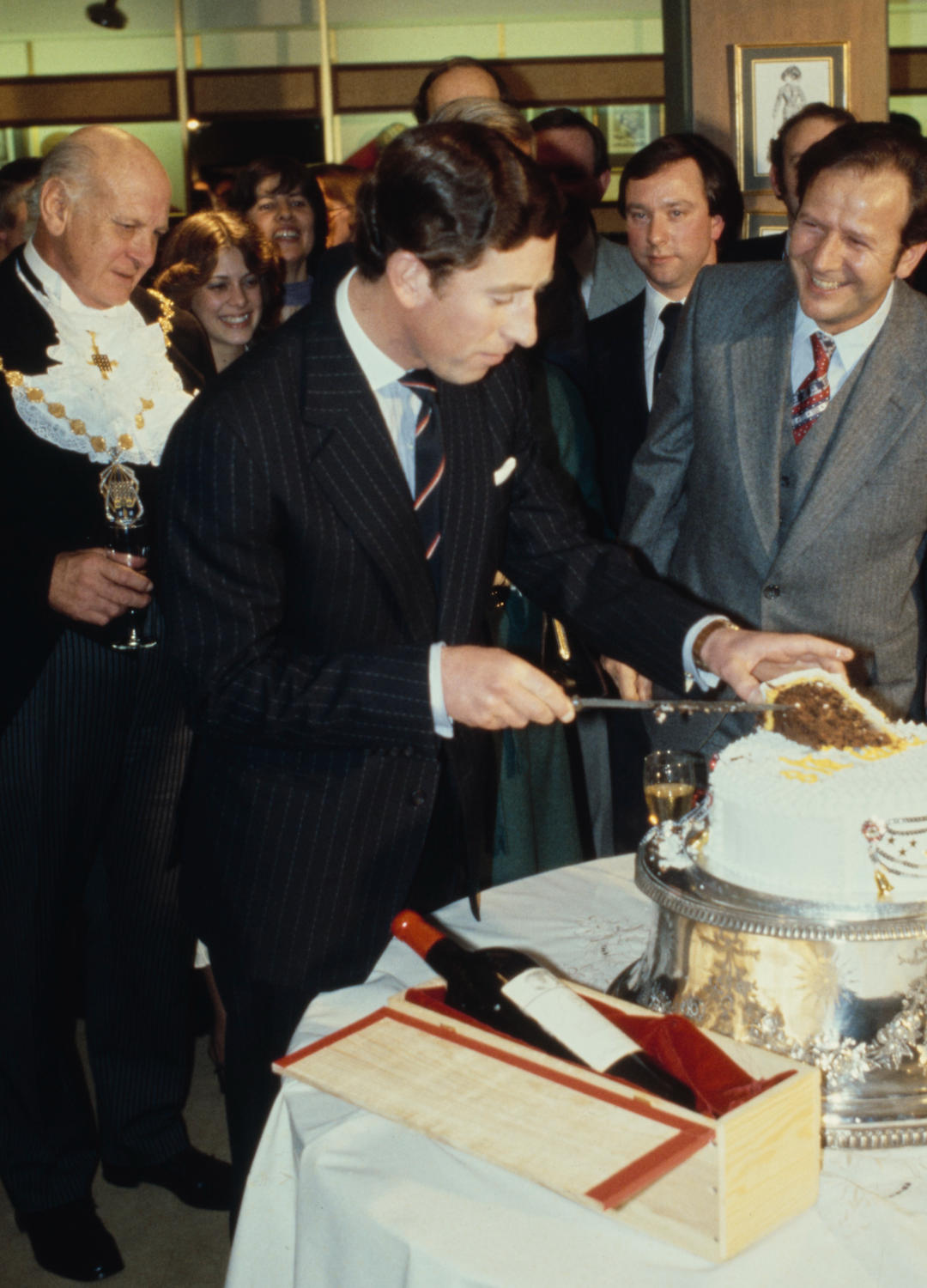 Charles, Prince of Wales pictured cutting a cake to celebrate his 30th birthday in an shop on Regent Street in London, England, 14th November 1978. The Prince had switched on Regent Street's traditional Christmas lights