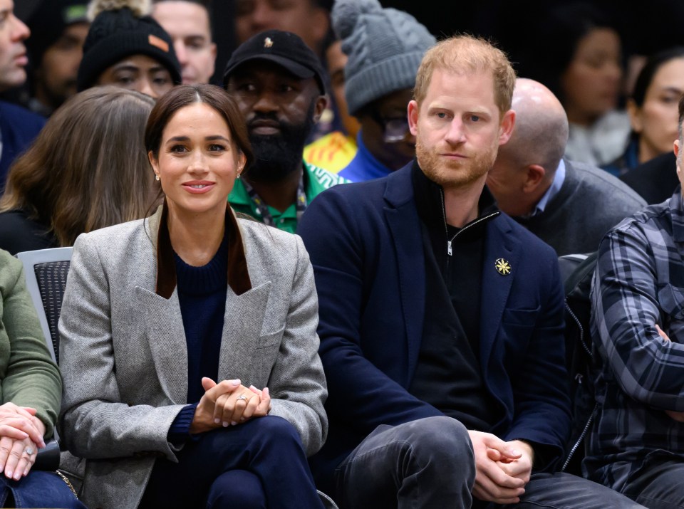 Meghan, Duchess of Sussex, and Prince Harry, Duke of Sussex, at a wheelchair basketball match.
