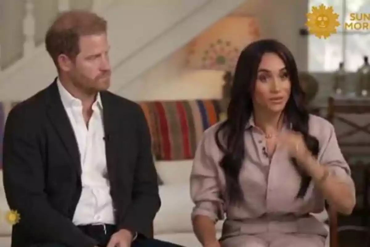 Prince Harry and Meghan Markle sitting on a couch during an interview on a morning television show.