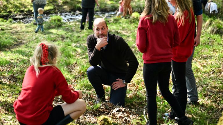 The Prince of Wales, known as the Duke of Rothesay when in Scotland, speaks with pupils from Lochdonhead primary school during a visit at the Ardura Community Forest