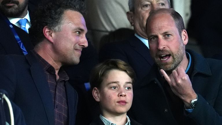 Prince William and Prince George in the stands.. Pic: PA