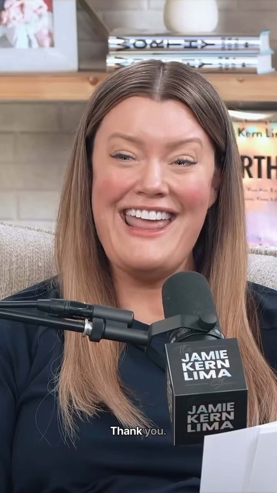 Jamie Kern Lima podcast guest smiling into microphone.