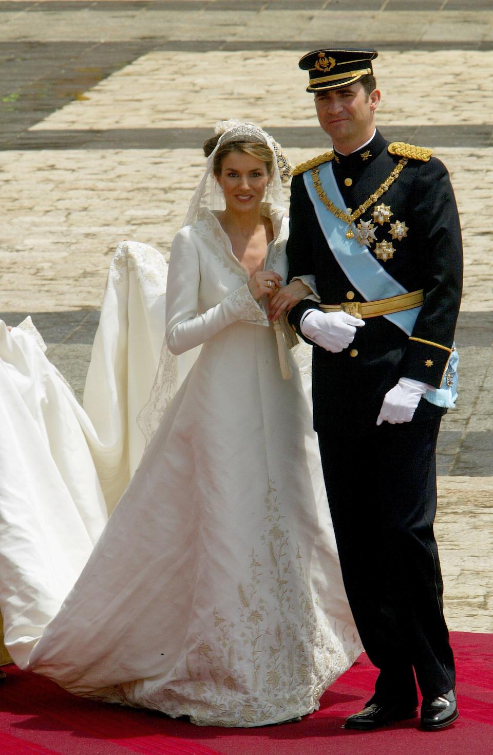 Queen Letizia on her wedding day standing outside the church with King Felipe
