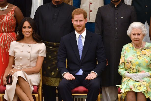 Meghan, Duchess of Sussex, Prince Harry, Duke of Sussex and Queen Elizabeth II at the Queen's Young Leaders Awards Ceremony at Buckingham Palace on June 26, 2018