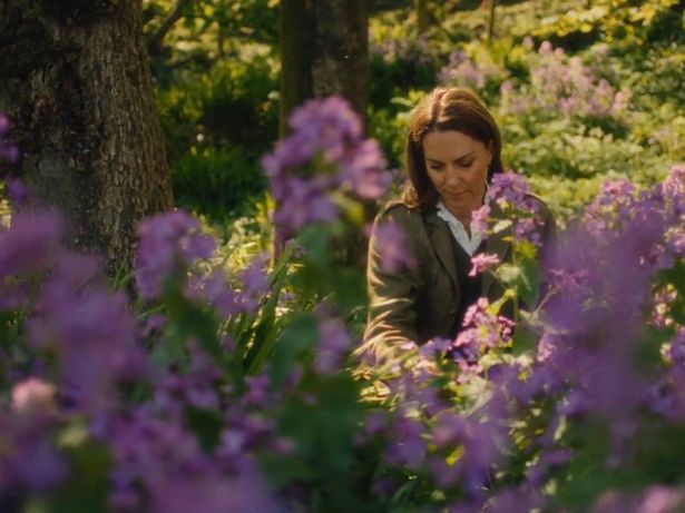 Kate walks through the flowers