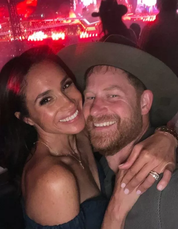 Meghan and Prince Harry hugging at a Beyoncé concert