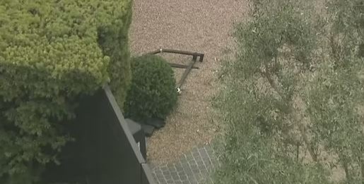 Aerial view of damaged gates at Jennifer Aniston's home after a car crash.