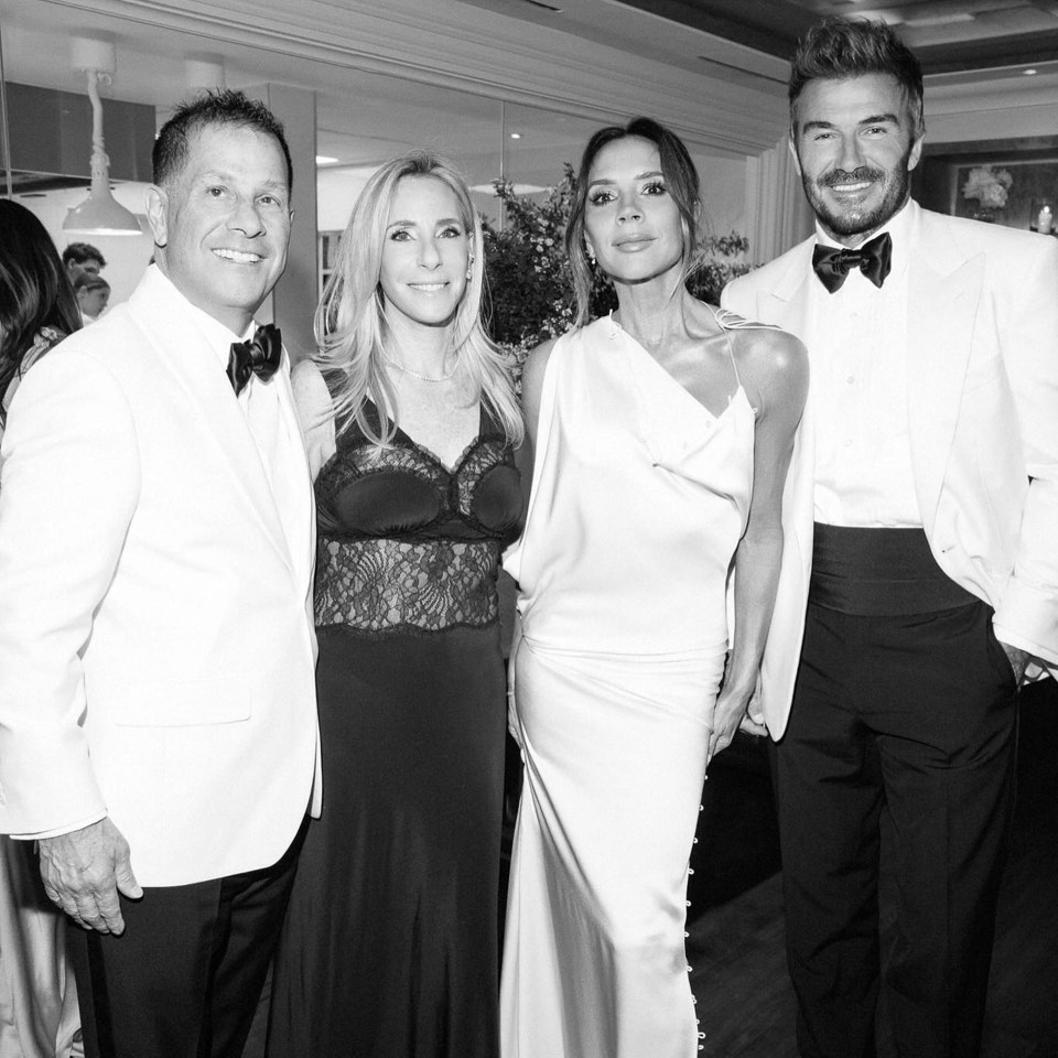Black and white photo of David Beckham, Victoria Beckham, and two other guests at a party.