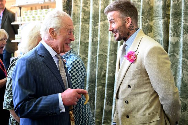 David Beckham wearing a David Austin Roses "King's Rose" speaks with King Charles III, patron of the Royal Horticultural Society at the Highgrove stand during a visit to the RHS Chelsea Flower Show
