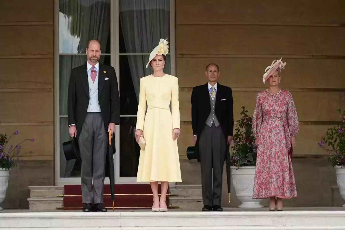A group of elegantly dressed people posing on a staircase in front of a building with large windows and flower pots. A group of elegantly dressed people posing on a staircase in front of a building with large windows and flower pots.