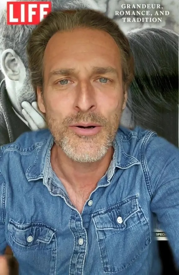 Man in denim shirt in front of a LIFE magazine cover.