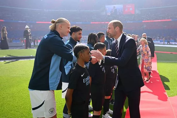 Prince William, Prince of Wales shakes hands with Erling Haaland of Manchester City prior to the Emirates FA Cup Final match