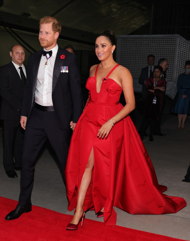 Prince Harry and Meghan Markle on a red carpet.