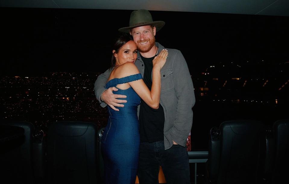couple posing together at an event with a city view in the background