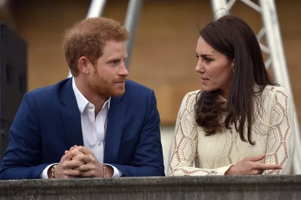 Prince Harry and Kate Middleton stood side-by-side, talking