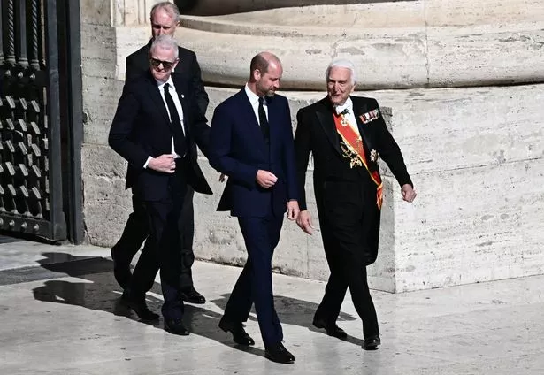 William is guided to his seat in St Peter's Square 