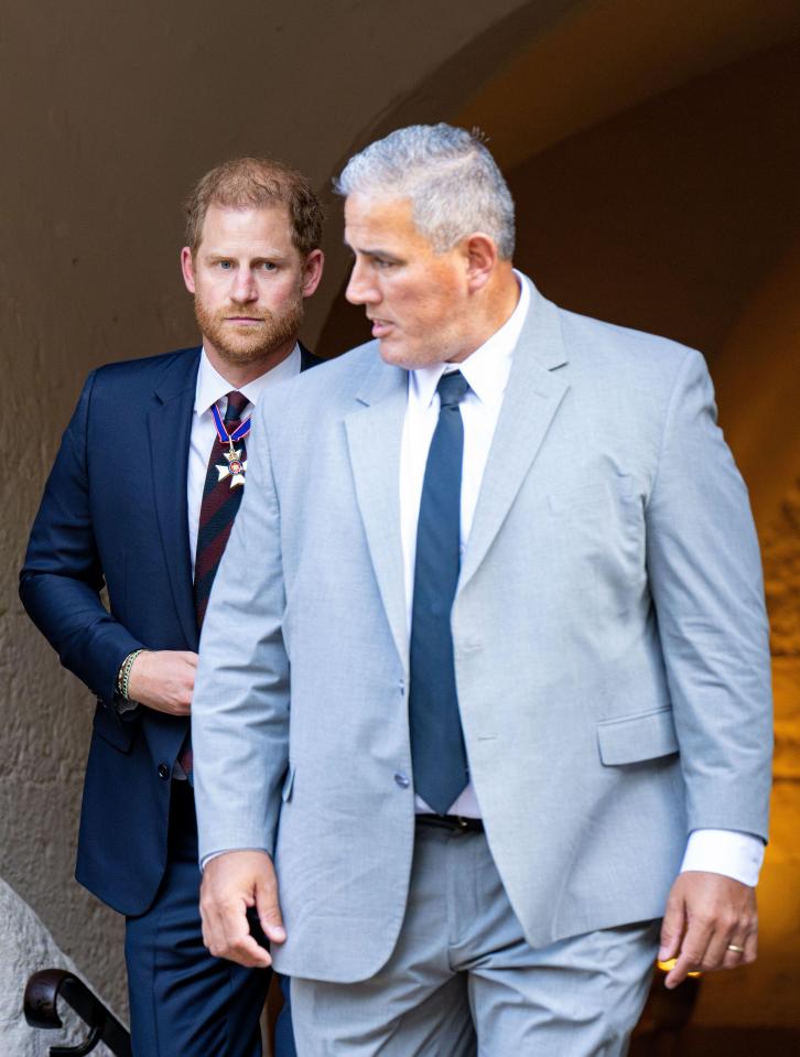 Prince Harry with his head of security at a St. Paul's Cathedral service.