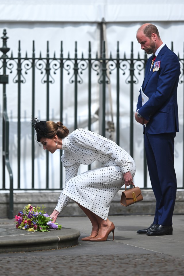 Princess Catherine placing flowers at a memorial with Prince William standing nearby.