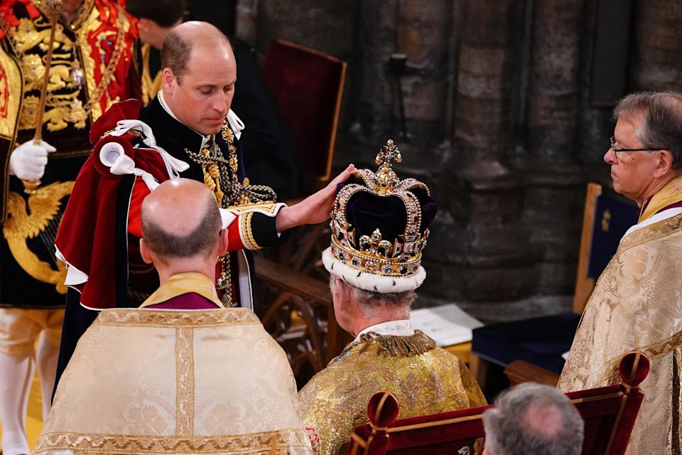 Prince William placing his hand on King Charles's crown at his coronation
