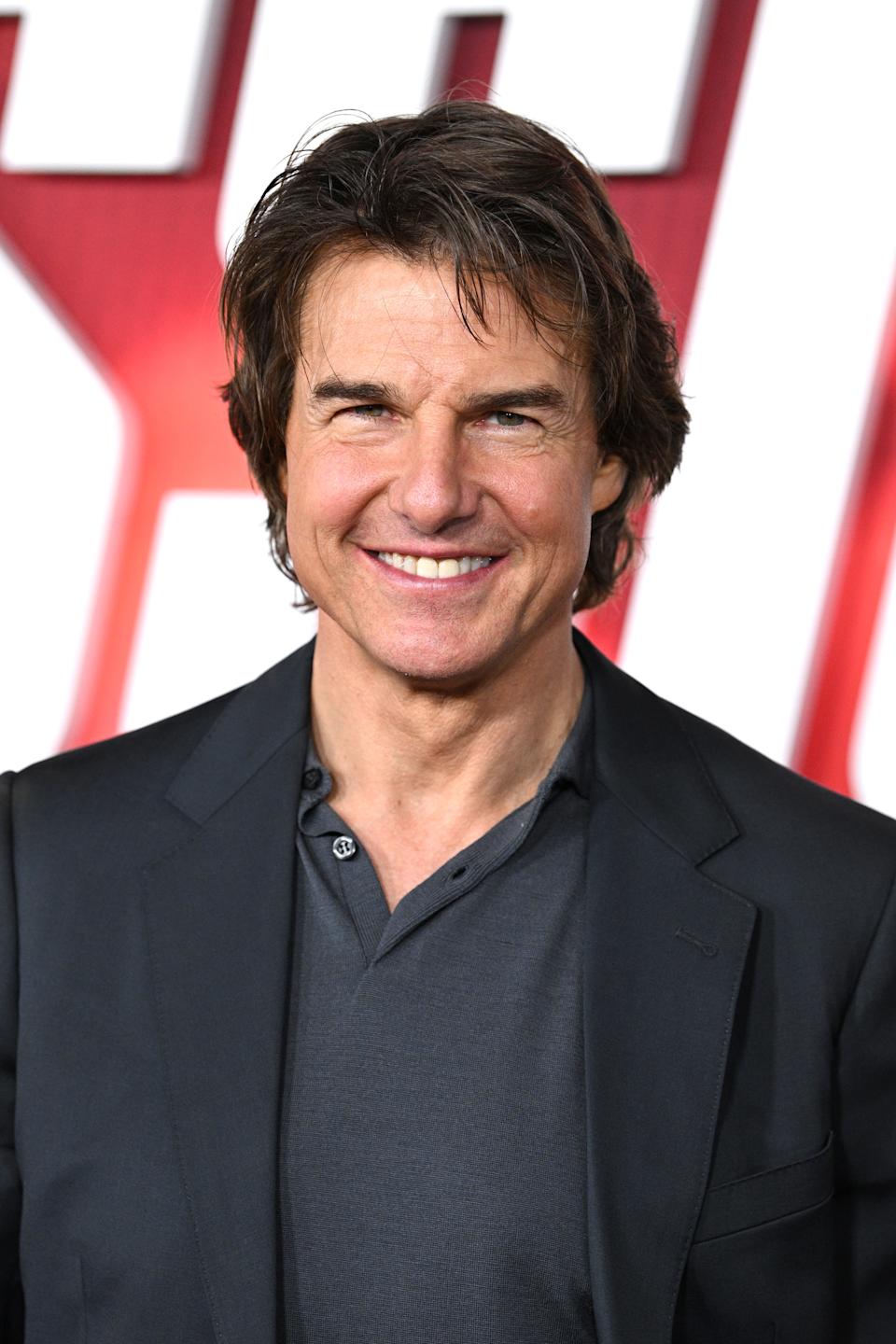 Tom Cruise smiling on a red carpet