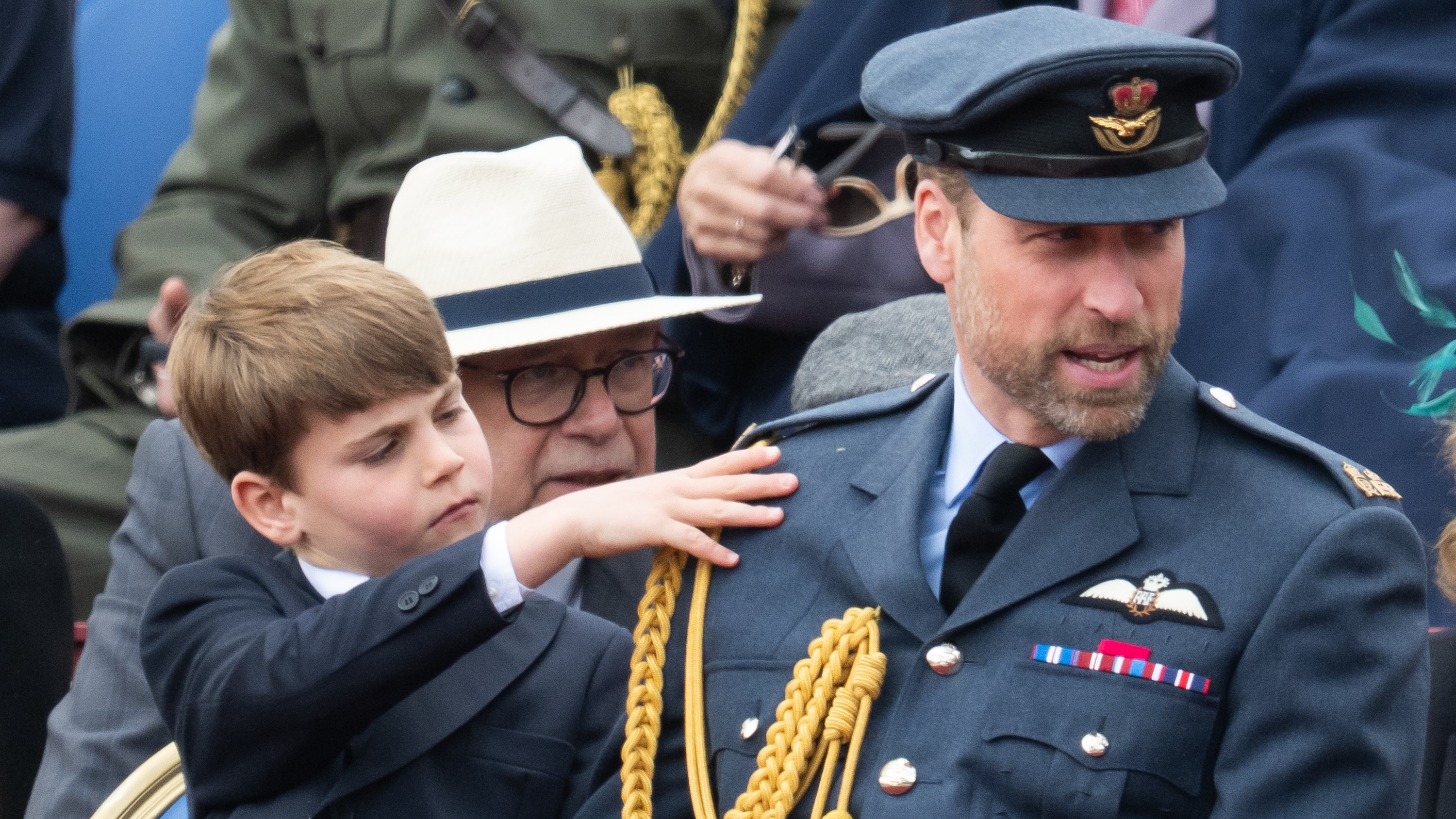 Prince Louis touches Prince William's shoulder during the military procession to mark the 80th anniversary of VE Day on May 05, 2025