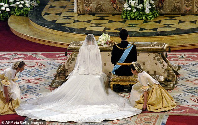 Created by Spanish designer Manuel Pertegaz, Letizia's gown features a structured silhouette elevated by a stand up collar and dramatic 15-foot train