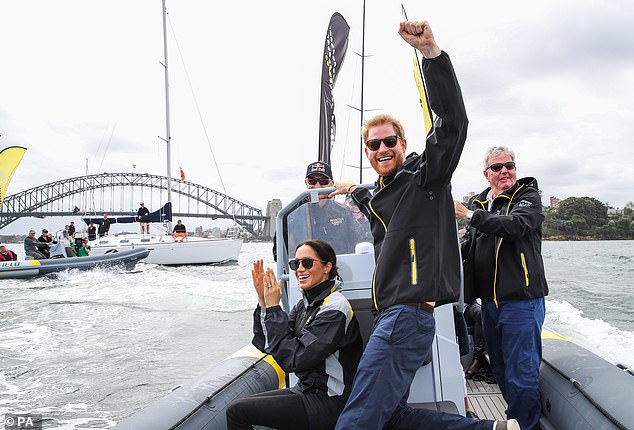 The Sussexes cheer on competitors taking part in a sailing event for the Invictus Games in Sydney Harbour