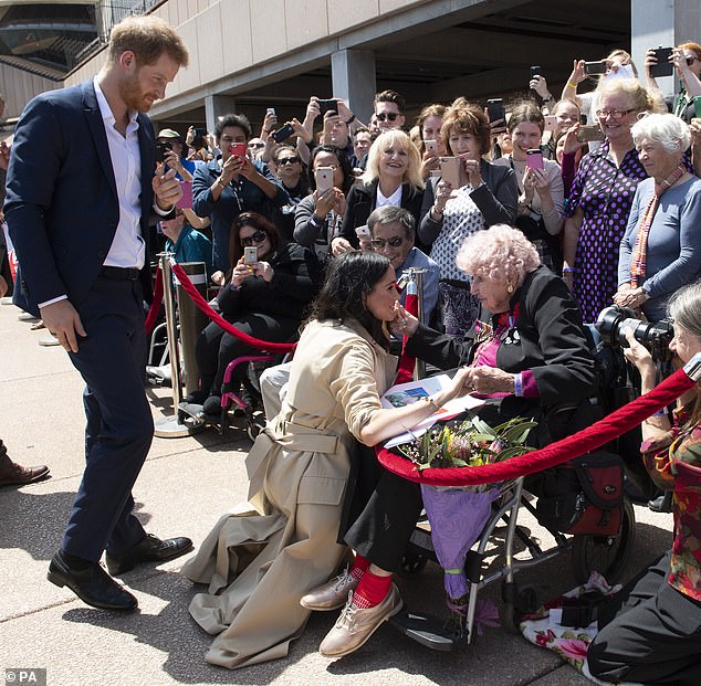Meghan speaks to a 97-year-old woman during a walkabout outside Sydney Opera House