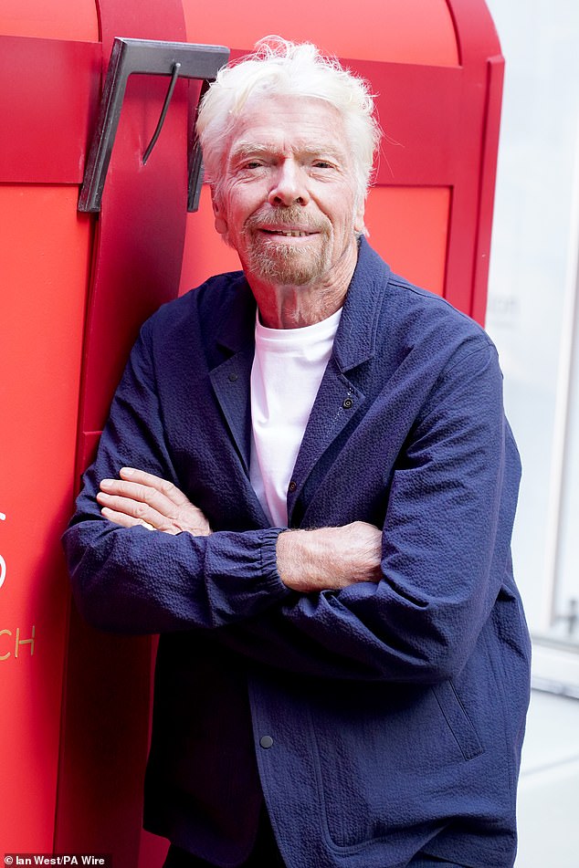 Sir Richard Branson with a giant Virgin Hotels branded red suitcase for the grand opening celebrations of Virgin Hotels London Shoreditch, in front of St Paul's Cathedral, Londo