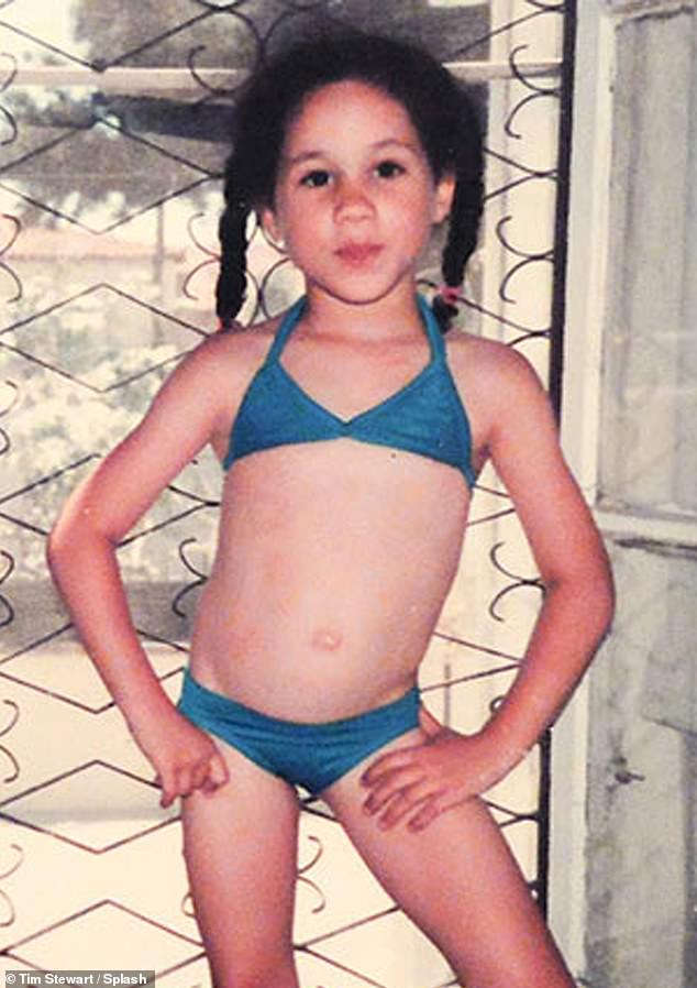Meghan as a child in California wearing a blue two-piece swimsuit