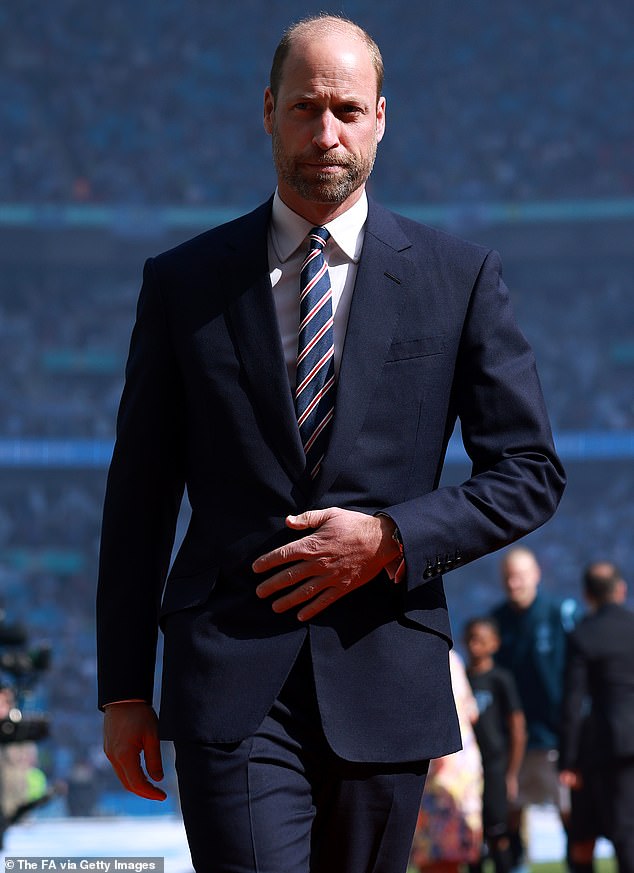 Prince William appeared in an elegant navy suit with a white shirt and navy and pink striped tie