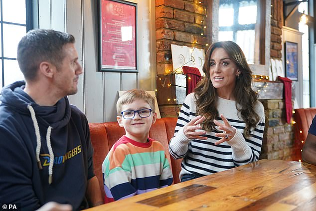 In November 2023 she met Grayson Stevenson (centre), 5, and his dad, Mark Stevenson (left), during a visit to 'Dadvengers', a community for dads and their children, in Arnos Grove, north London, as part of her Shaping Us campaign on early childhood
