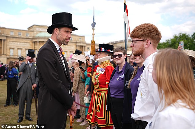 The Prince of Wales talks to guests during a Royal Garden Party at Buckingham Palace