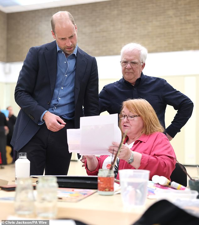 The Prince of Wales, known as the Duke of Rothesay when in Scotland, speaks to a member of an arts class during a visit to Leith Community Centre