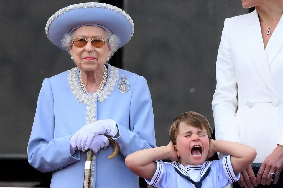 PHOTO: Prince Louis of Cambridge holds his ears as he stands next to Britain's Queen Elizabeth II to watch a special flypast from Buckingham Palace balcony, as part of Queen Elizabeth II's platinum jubilee celebrations, in London, on June 2, 2022. (Daniel Leal/AFP via Getty Images, FILE)