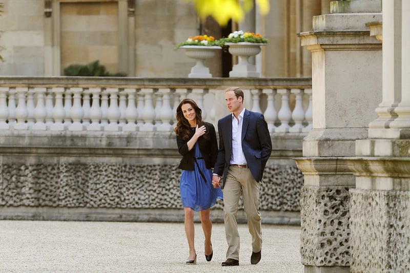 Prince William, Duke of Cambridge and Catherine, Duchess of Cambridge walk hand in hand from Buckingham Palace the day after their wedding to a waiting helicopter as they leave for a secret honeymoon location, on April 30, 2011 in London