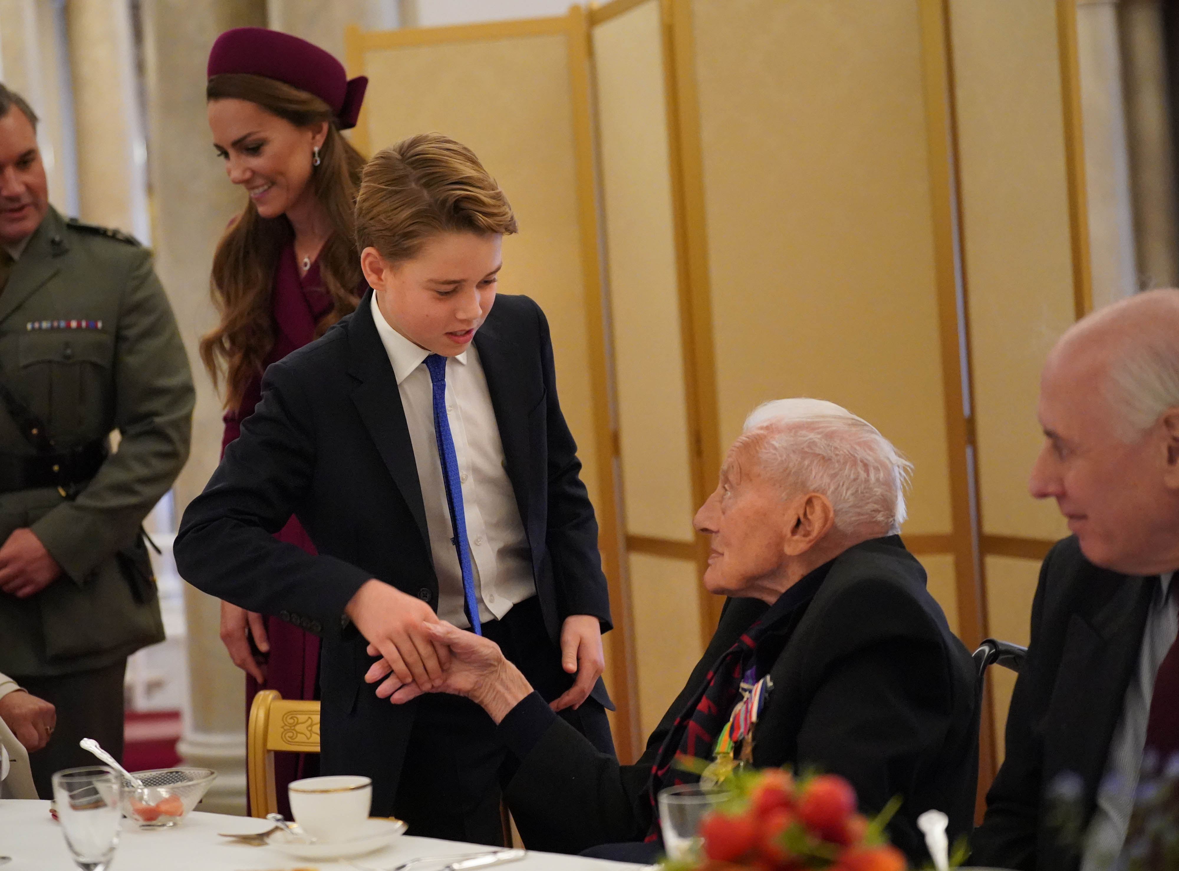 Prince George shaking hands with a war veteran