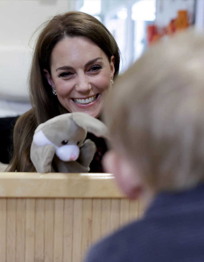 Kate Middleton smiling warmly at a child while holding a stuffed animal, related to Meghan Markle clash details. Kate Middleton smiling warmly at a child while holding a stuffed animal, related to Meghan Markle clash details.